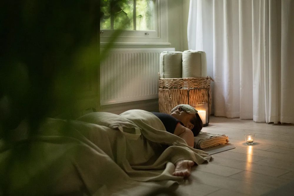 A quiet, candlelit restorative space at Atelier108